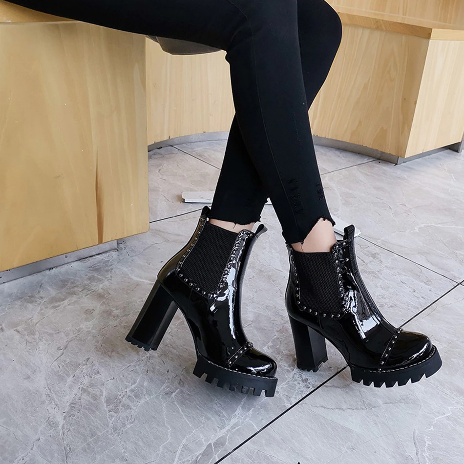 Rock style genuine leather ankle boots with round toe and rivets, featuring high heels and a stylish platform.