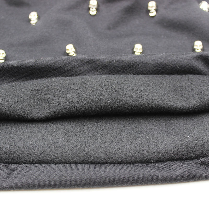 Close-up of a black knitted rave hat with skulls and hoop details, showcasing its unique rock style.