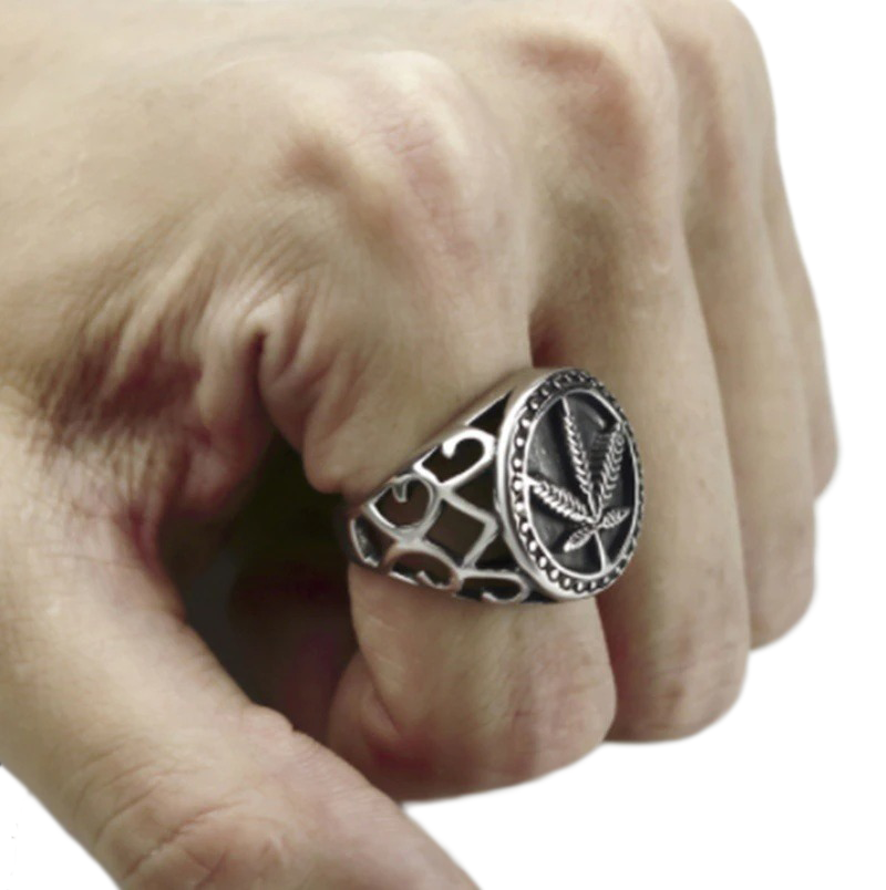 Stylish hemp leaf ring on a hand, showcasing vintage biker jewelry design made of stainless steel.