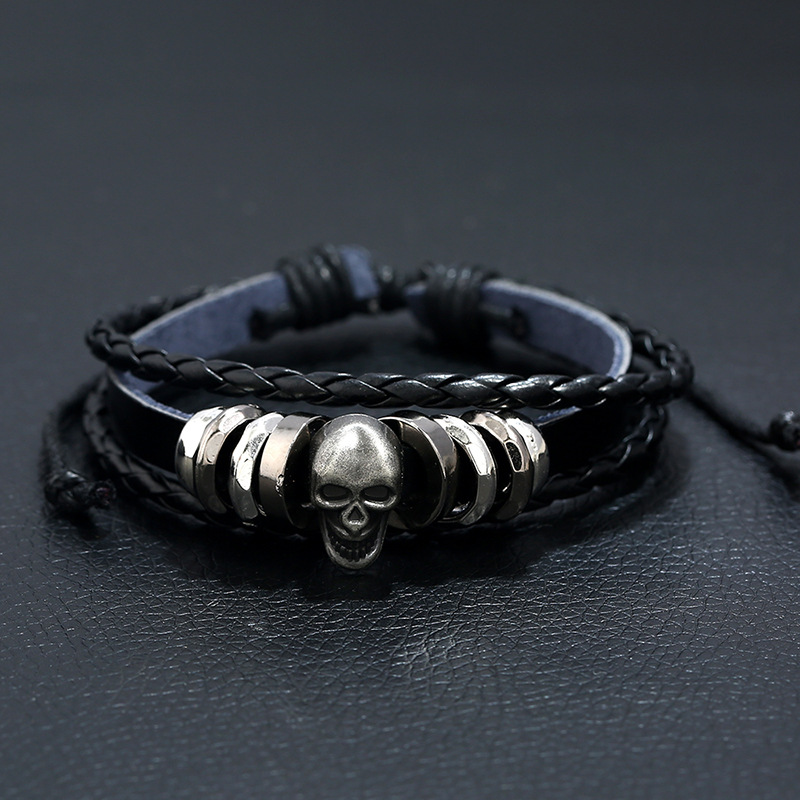 Multi-layer leather skull bracelet for men and women, stylish rock-style accessory with silver skull charm.