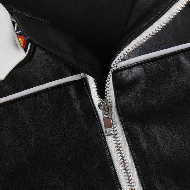Close-up of women's PU leather patchwork jacket zipper highlighting quality craftsmanship in alternative fashion.