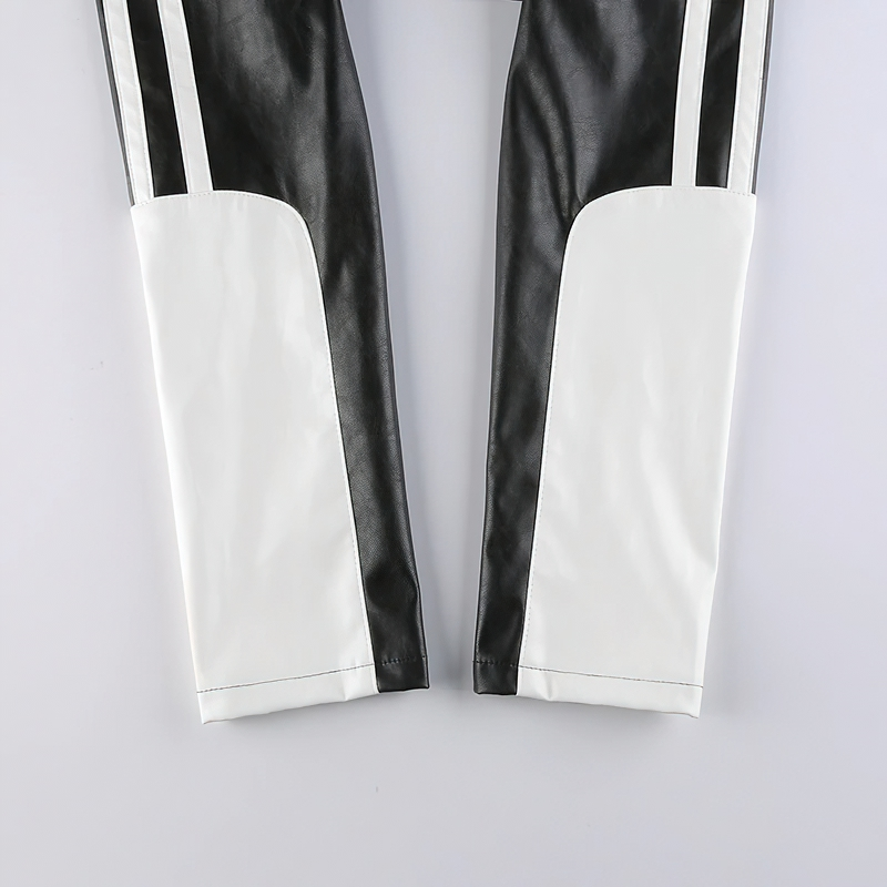 Close-up of black and white PU leather cropped jacket sleeves with sporty stripes for women.