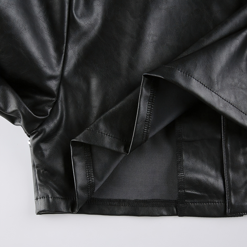 Close-up of the interior of a black PU leather cropped jacket showcasing the patchwork detail and high-quality finish.