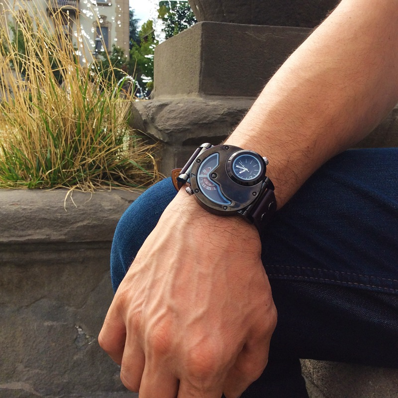 Man's rock style quartz dual PU leather watch displayed on wrist, showcasing a modern and stylish design.