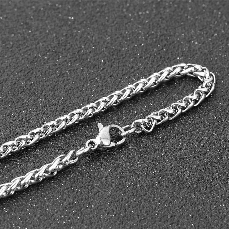 Close-up of a shiny silver stainless steel chain necklace with a secure clasp.