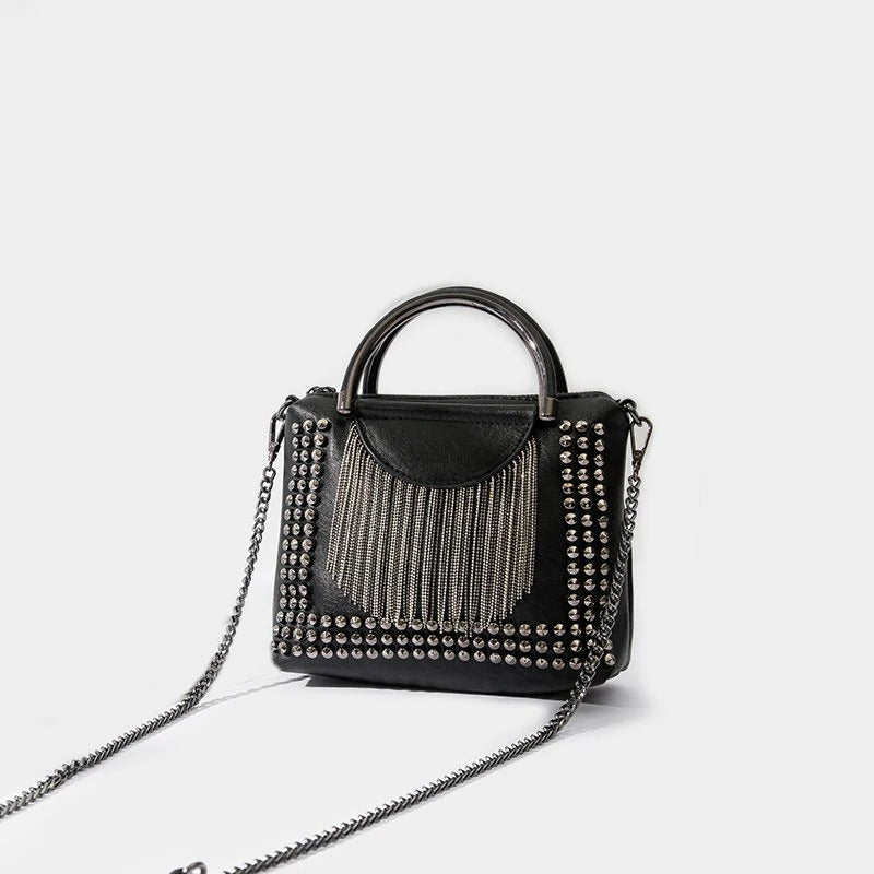 Stylish black rivet crossbody bag for women featuring chains and a fringed design, perfect for alternative fashion.
