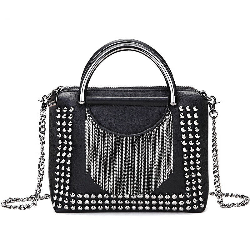 Rock style black crossbody bag with silver studs and fringe detail, perfect for alternative fashion lovers.