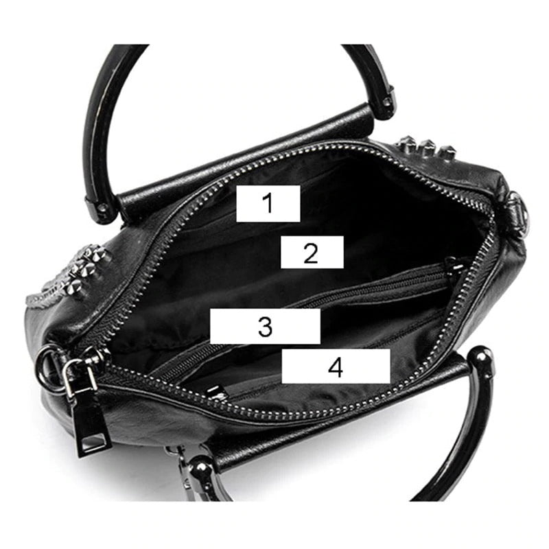 Interior view of rock style women's crossbody bag showing compartments for organized storage with chains and studs.