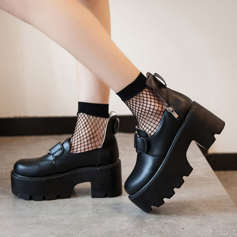 Women's chunky rock style pumps in black, featuring fishnet socks and platform heels for a gothic fashion statement.