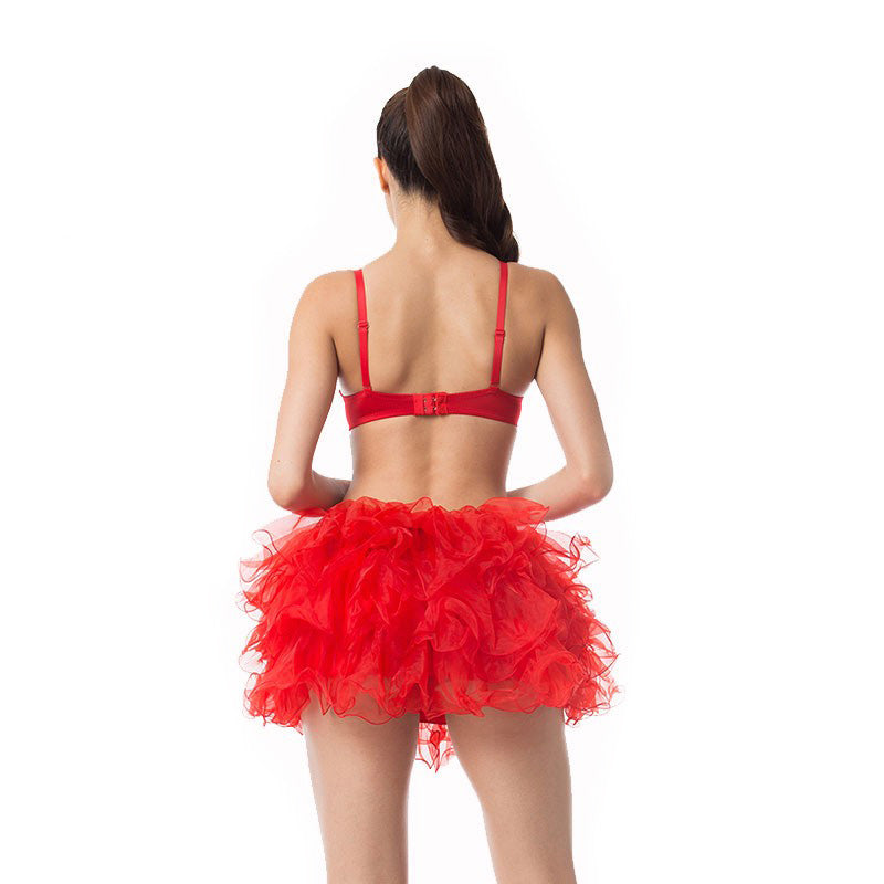 Back view of a model in a red push-up bra and ruffled red skirt, showcasing playful lingerie style.