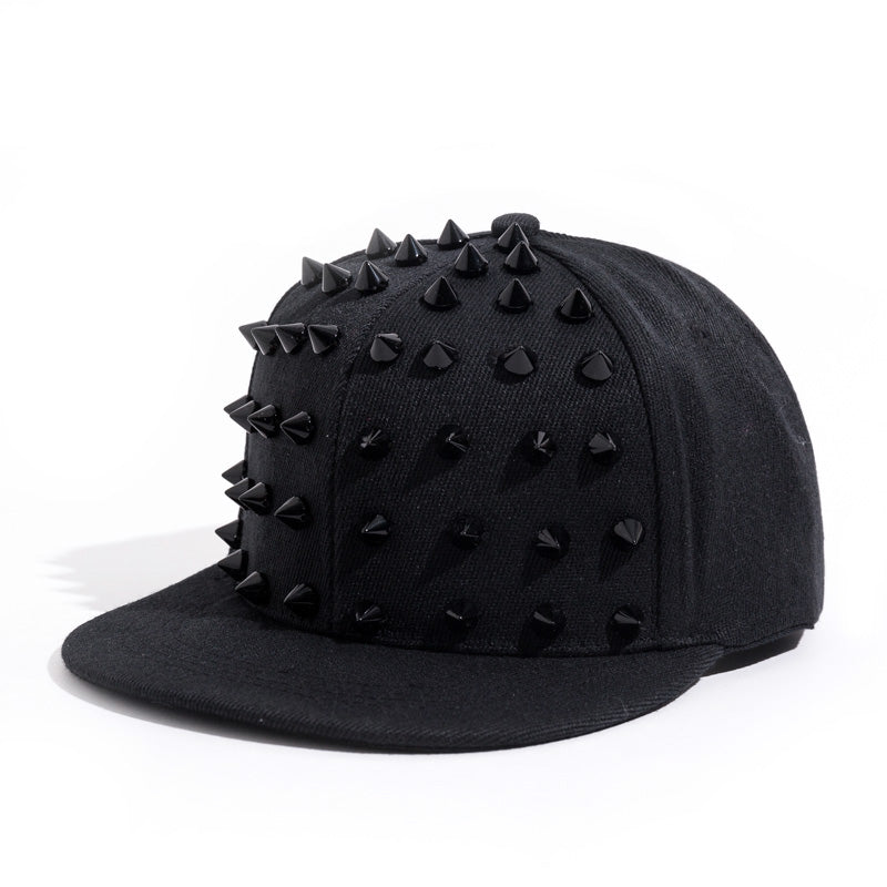 Black snapback cap with spiky studs, perfect for rock festivals and adding an edgy touch to your outfit.