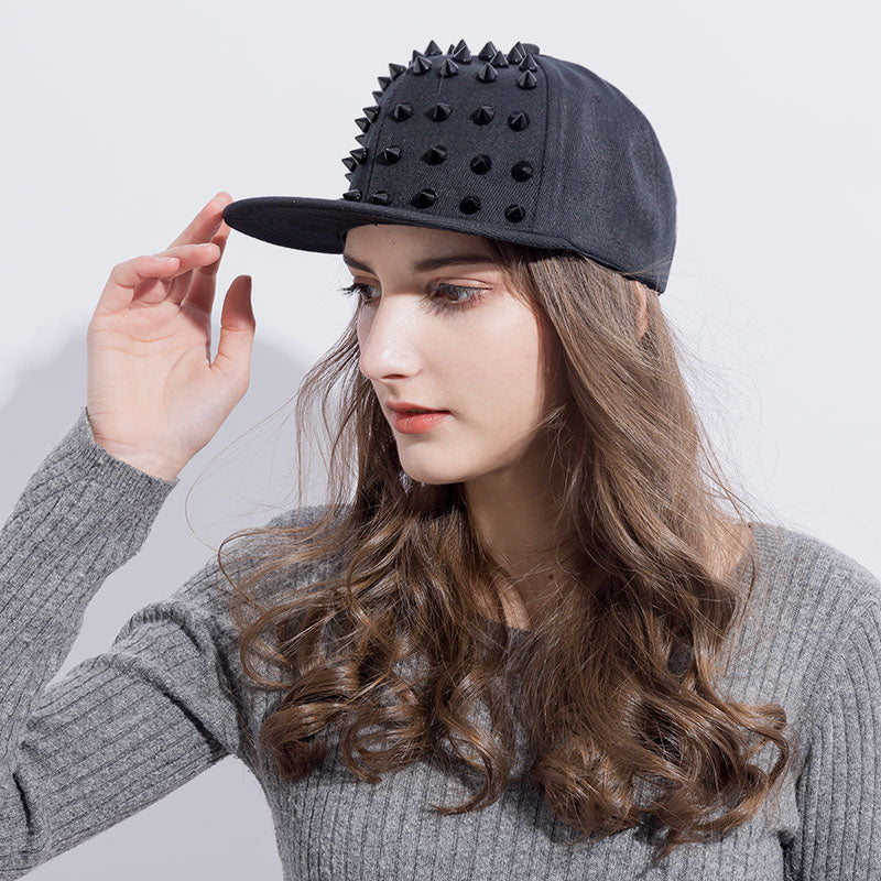 Woman wearing black studded spiky snapback cap, showcasing a punk rock style perfect for festivals and casual outings.