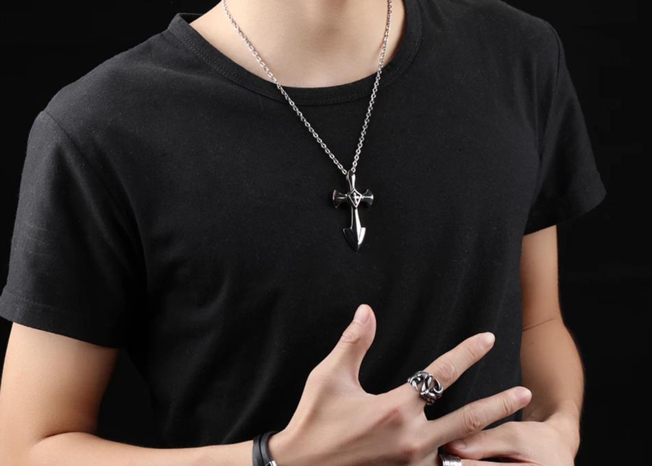 Rock style stainless steel cross pendant necklace on a model, showcasing edgy alternative jewelry fashion.
