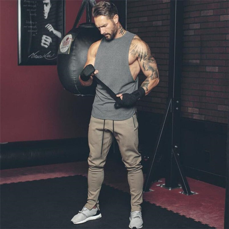 Stylish men's sleeveless tank top in gym, perfect for fitness and rock-inspired outfits.
