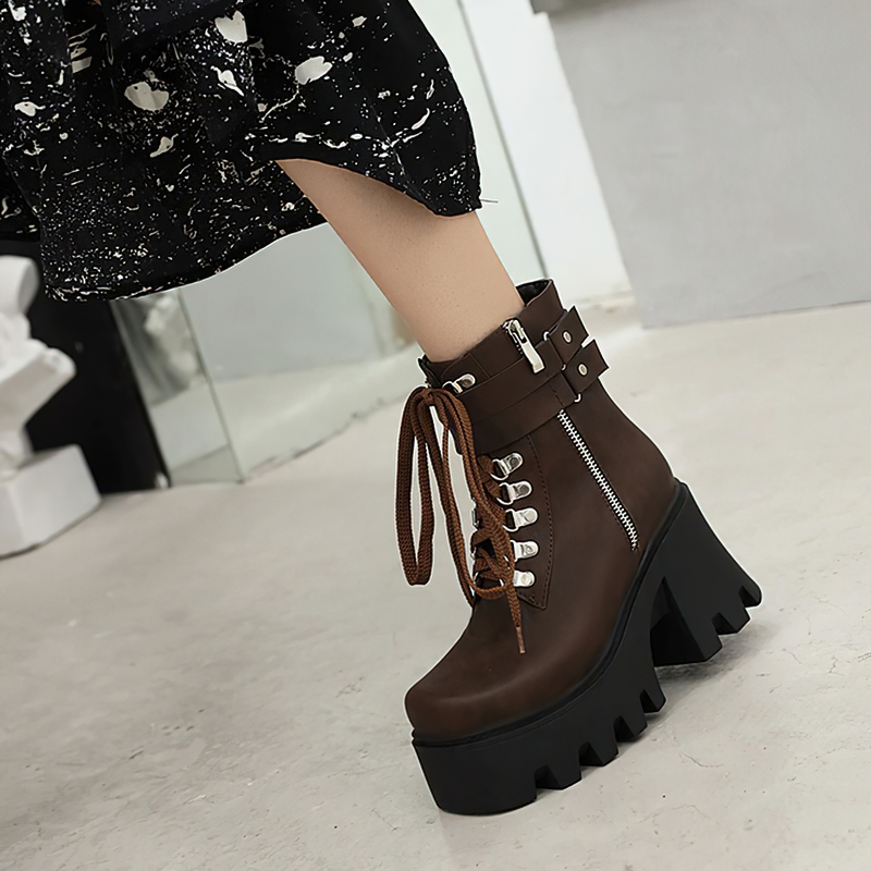 Brown lacing platform motorcycle boots with high heels, featuring buckles and a stylish design for rocker outfits.