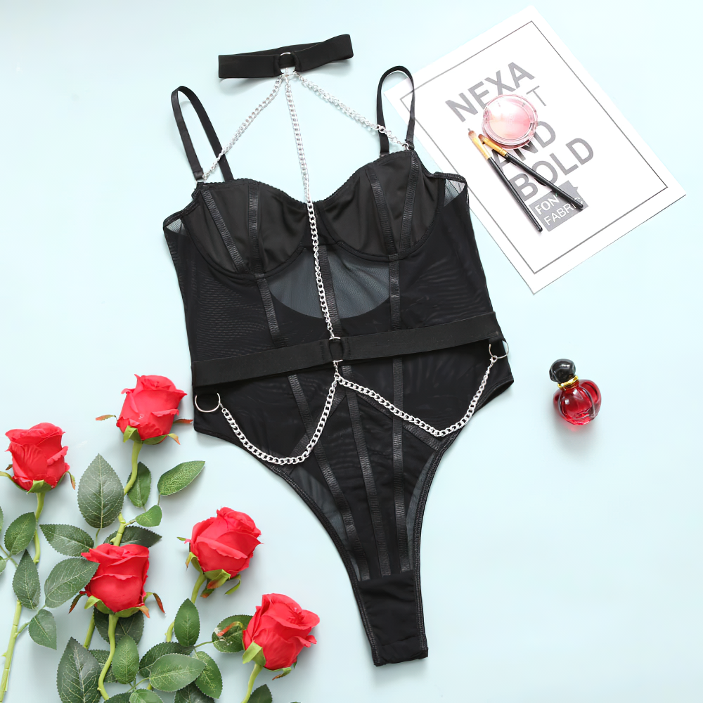 Stylish women’s black bodysuit with chain details and deep neck, surrounded by red roses and fashion accessories.