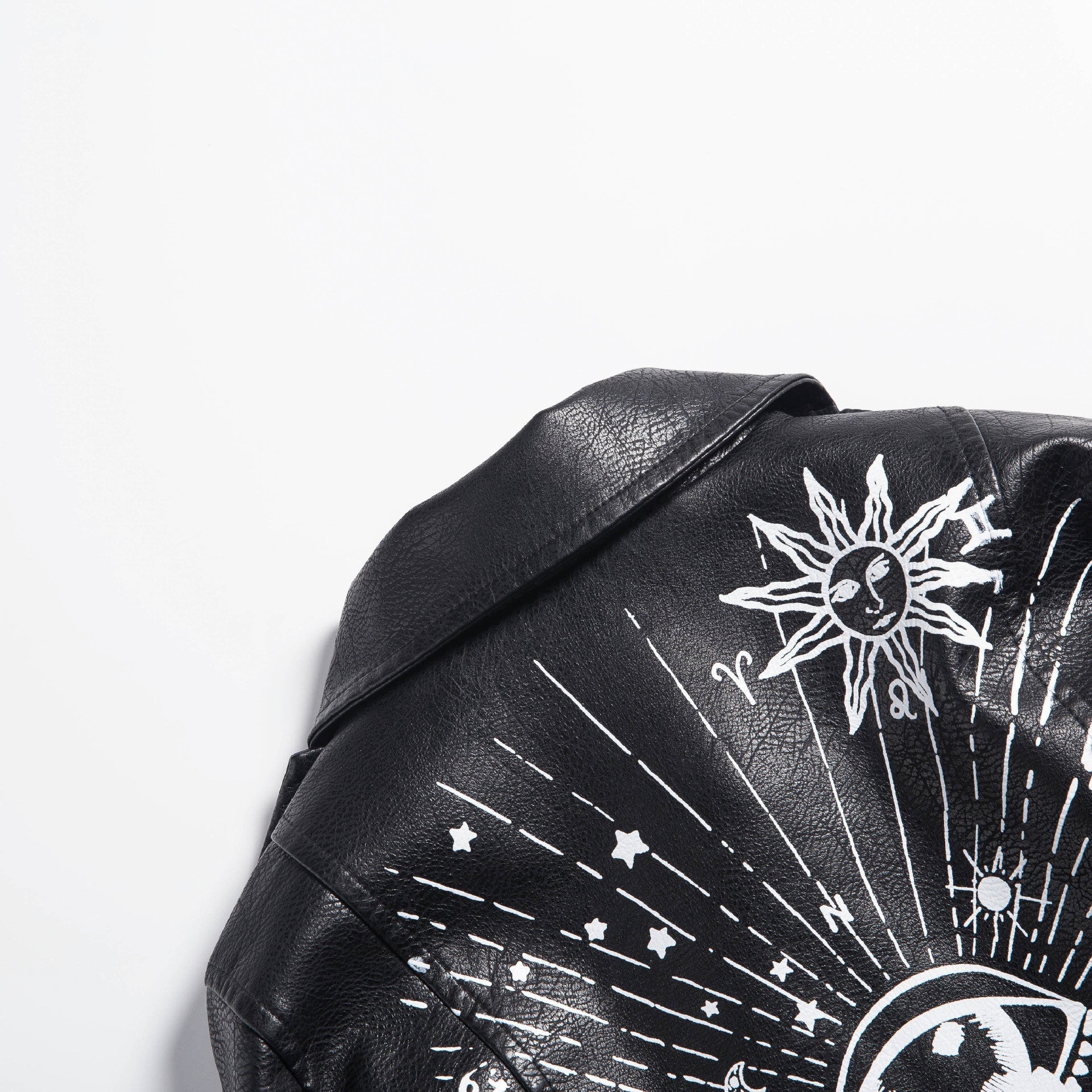 Close-up of women's faux leather motorcycle jacket with unique sun and moon 3D print design, perfect for rock style outfits.