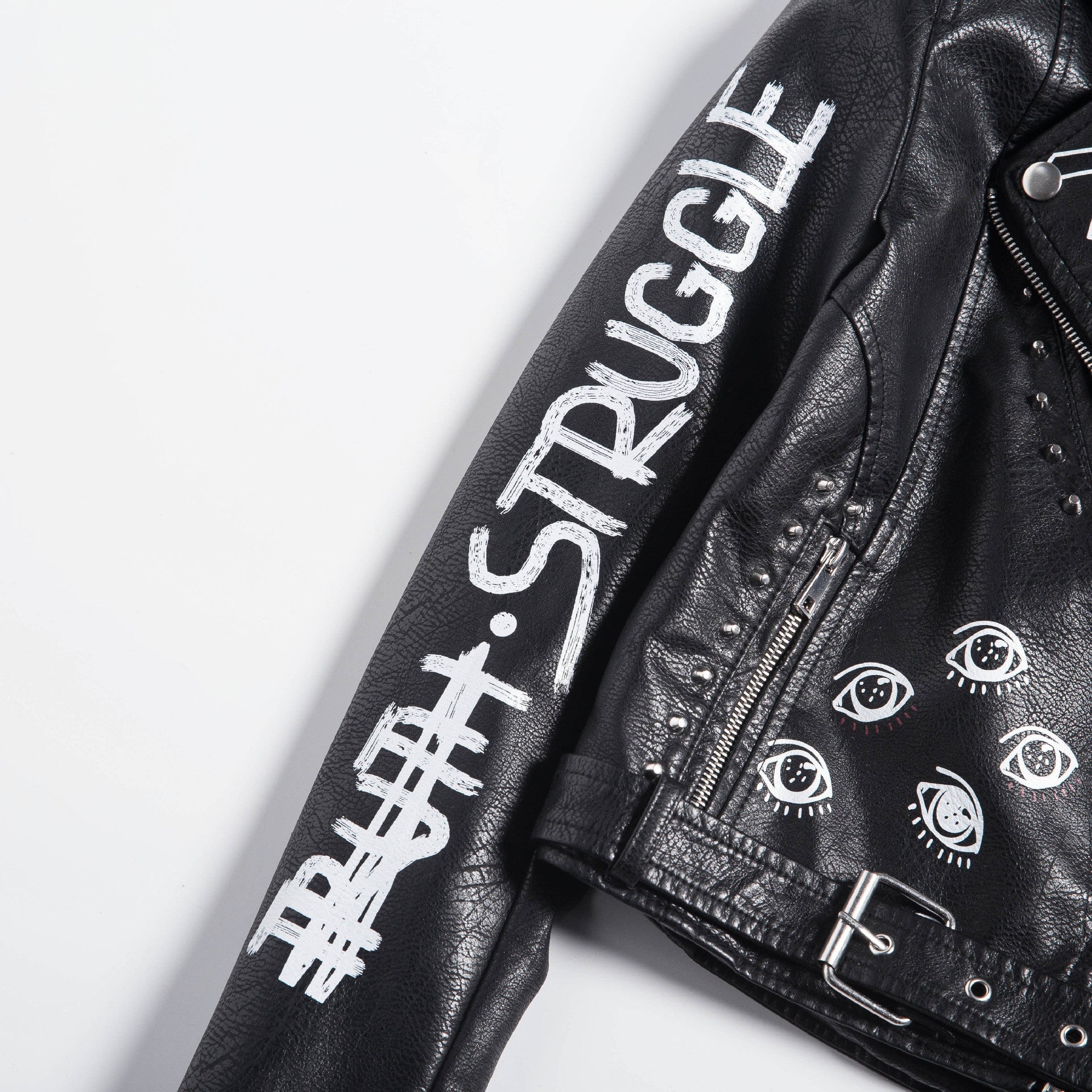Close-up of a black faux leather motorcycle jacket with unique 3D prints and studs, perfect for rock and goth styles.