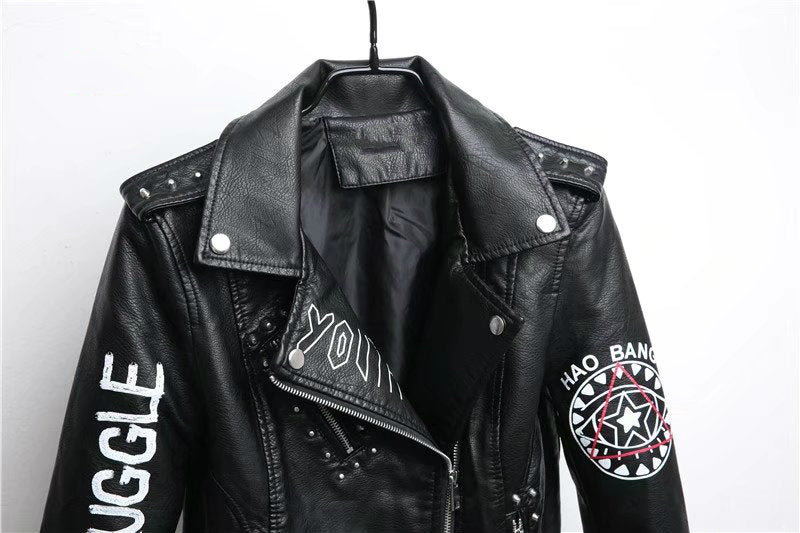 Close-up of women's faux leather motorcycle jacket with studs and 3D print, perfect for a rocker girl outfit.