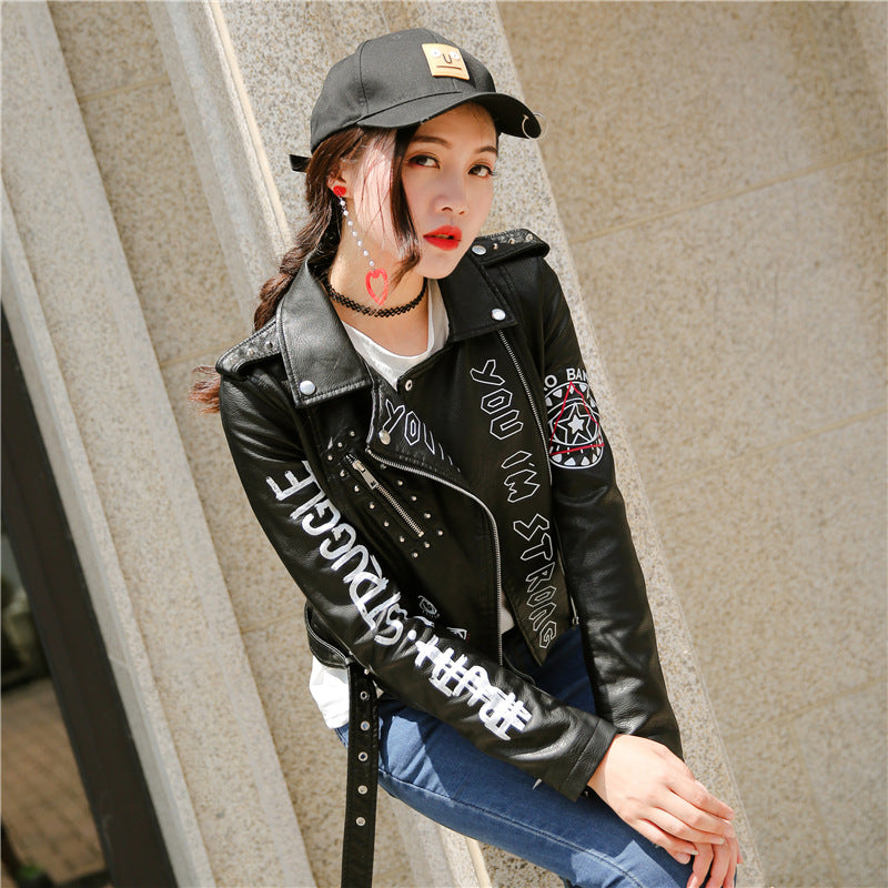 Trendy women's faux leather motorcycle jacket features edgy prints and studs, perfect for a rock or goth style.