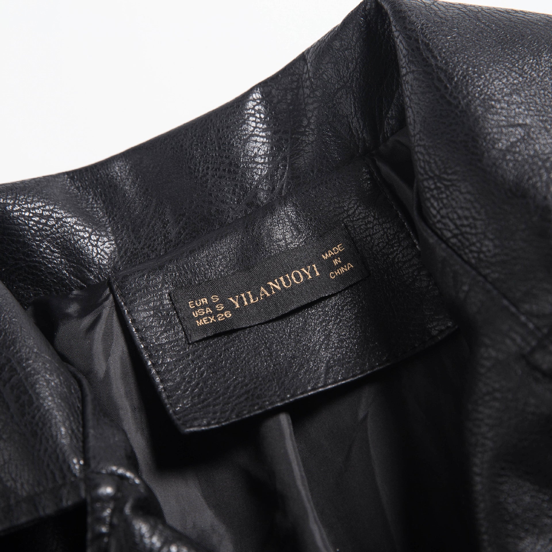 Interior label of a women's soft faux leather motorcycle jacket showing size and brand details.