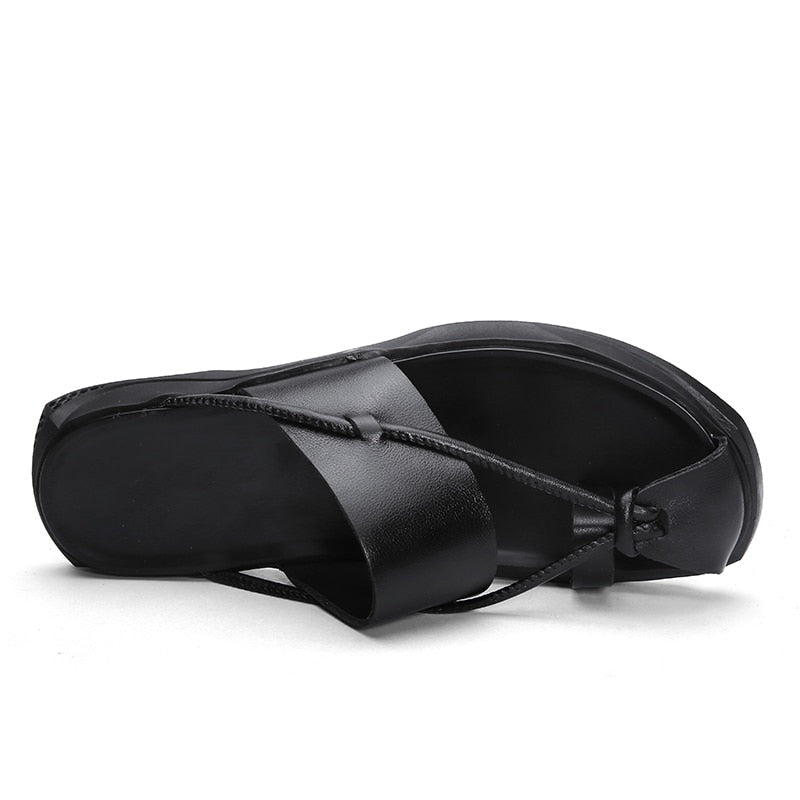 Rock'n'Roll style black leather flip flops with ankle-wrap design, perfect for casual summer beach outings.