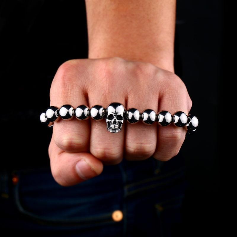 Round bead skull biker bracelet worn on a fist, showcasing stainless steel and a cool skeleton design.