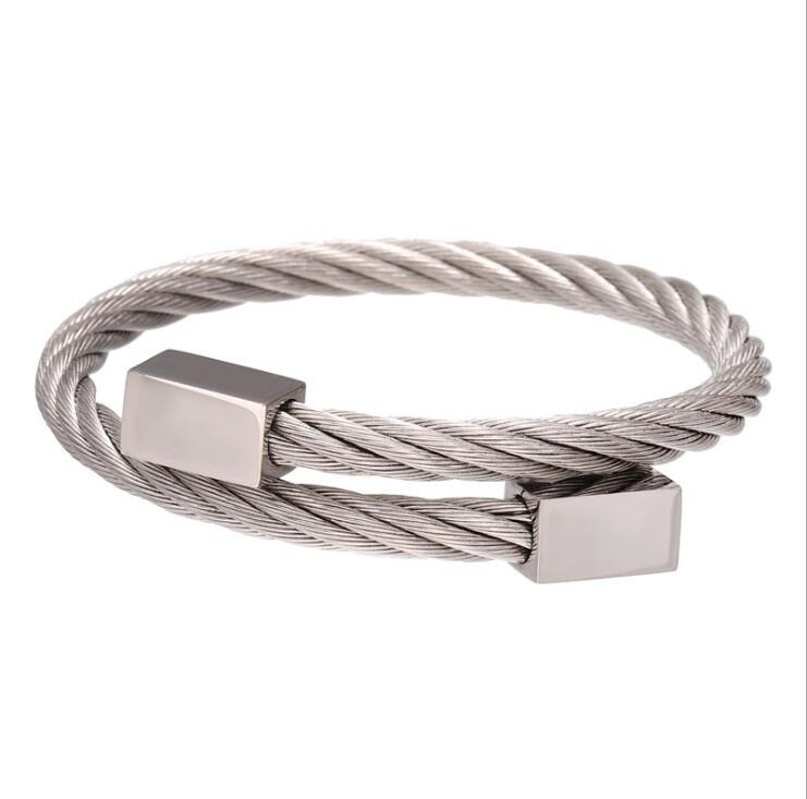 Stylish stainless steel bangle with twisted cable design and sleek metal accents, perfect for punk jewelry enthusiasts.