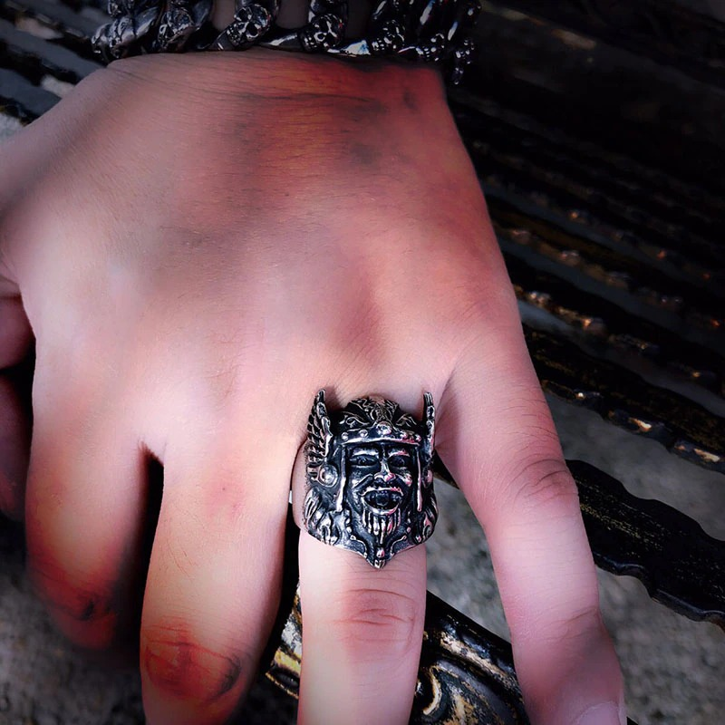 Hand displaying a Scandinavian stainless steel ring featuring Odin's head, representing Viking style and heroism.