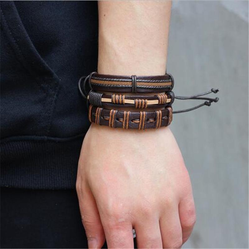 Stylish rock-style brown leather bracelets and braided wristbands on a man's arm, showcasing versatility and fashion.