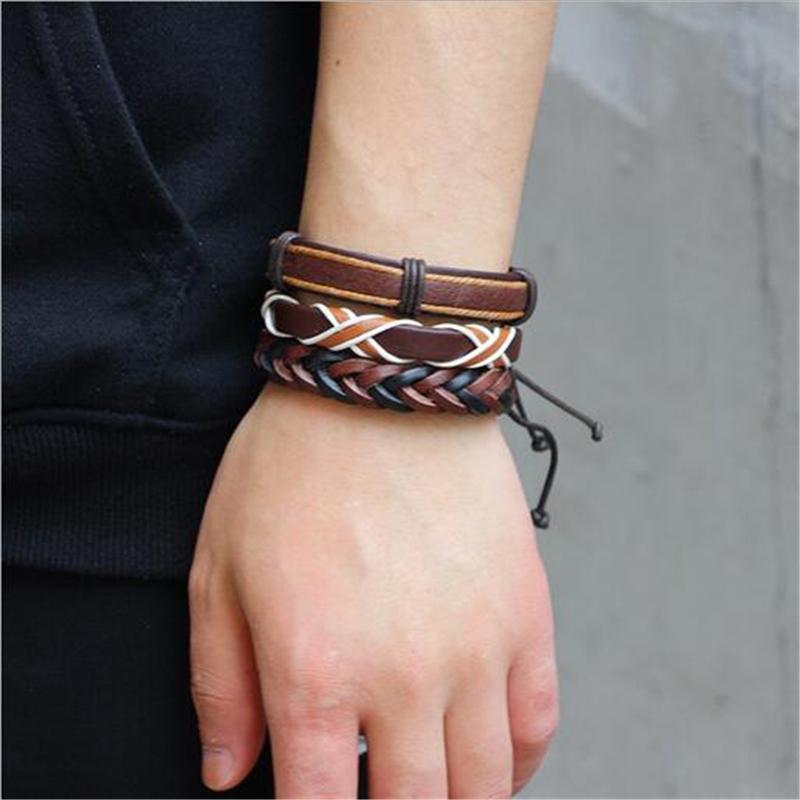Set of 6 rock-style brown leather bracelets and braided rope wristbands worn on a wrist.