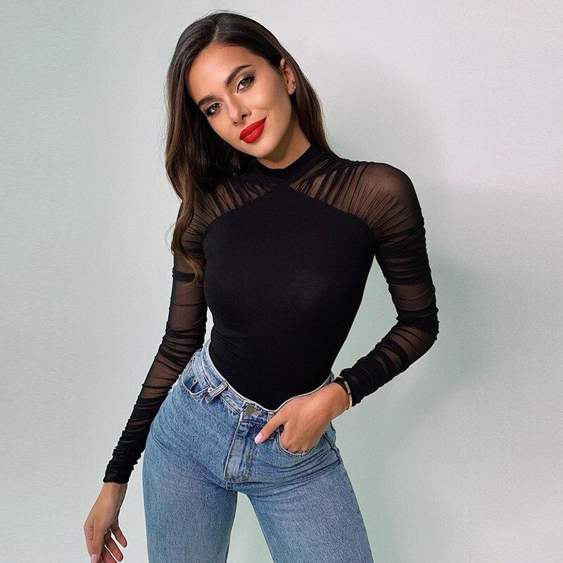 Stylish woman in a black long sleeve bodysuit paired with high-waisted jeans, showcasing a chic look.