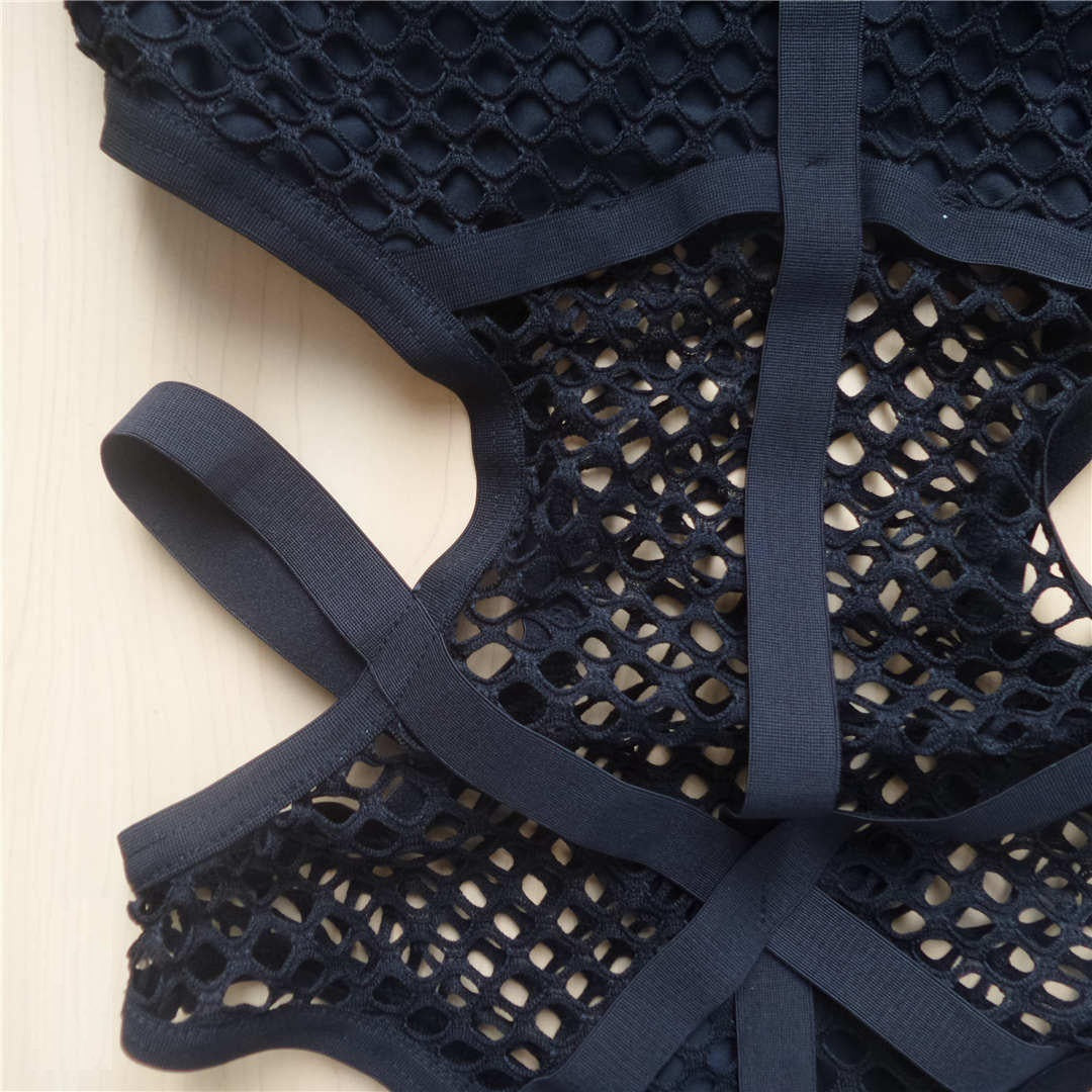 Close-up of sexy black net mesh women's one-piece swimsuit showcasing intricate mesh details and elegant straps.