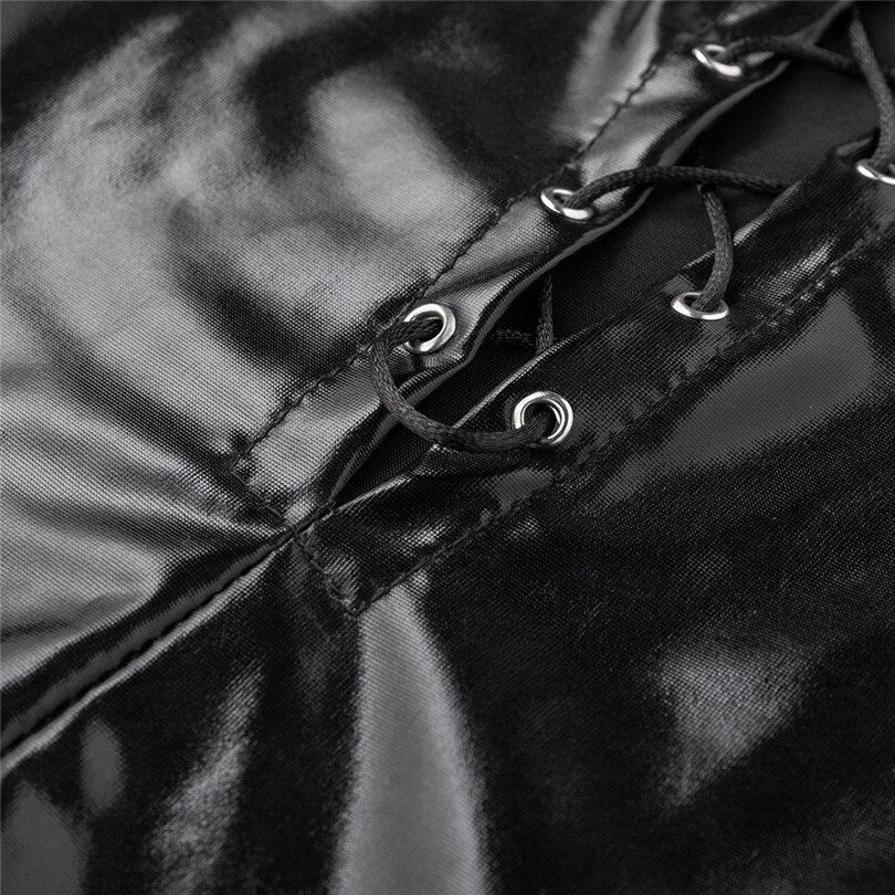 Close-up of the lace-up detail on a sexy black shiny bodysuit, showcasing glossy vinyl fabric and metallic grommets.