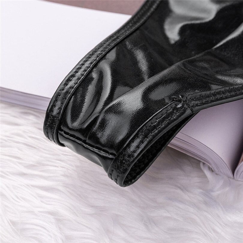 Close-up of shiny black vinyl bodysuit fabric, showcasing sleek texture and stylish design for gothic fashion lovers.