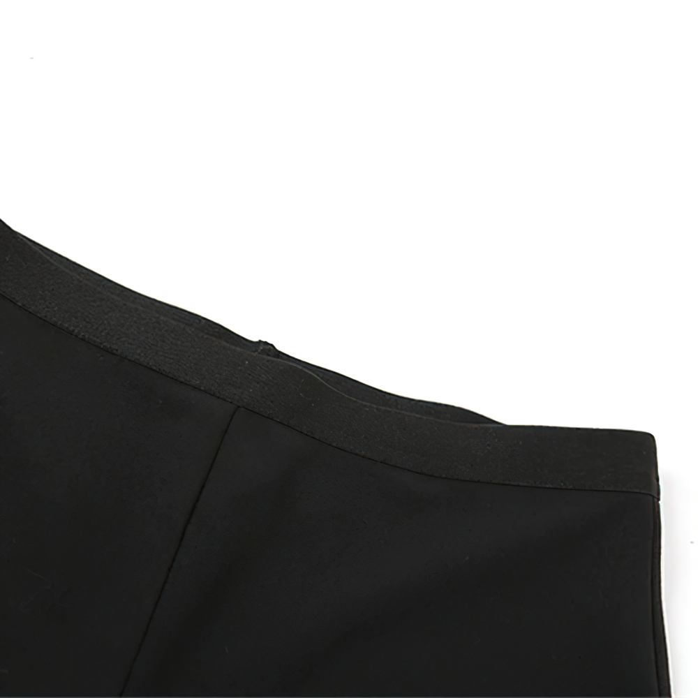 Close-up of the strapless edge of a sexy black women's asymmetrical mini dress, showcasing casual fashion elegance.