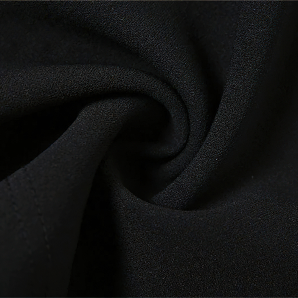 Close-up of soft black fabric, showcasing the smooth texture perfect for a stylish women's mini dress.