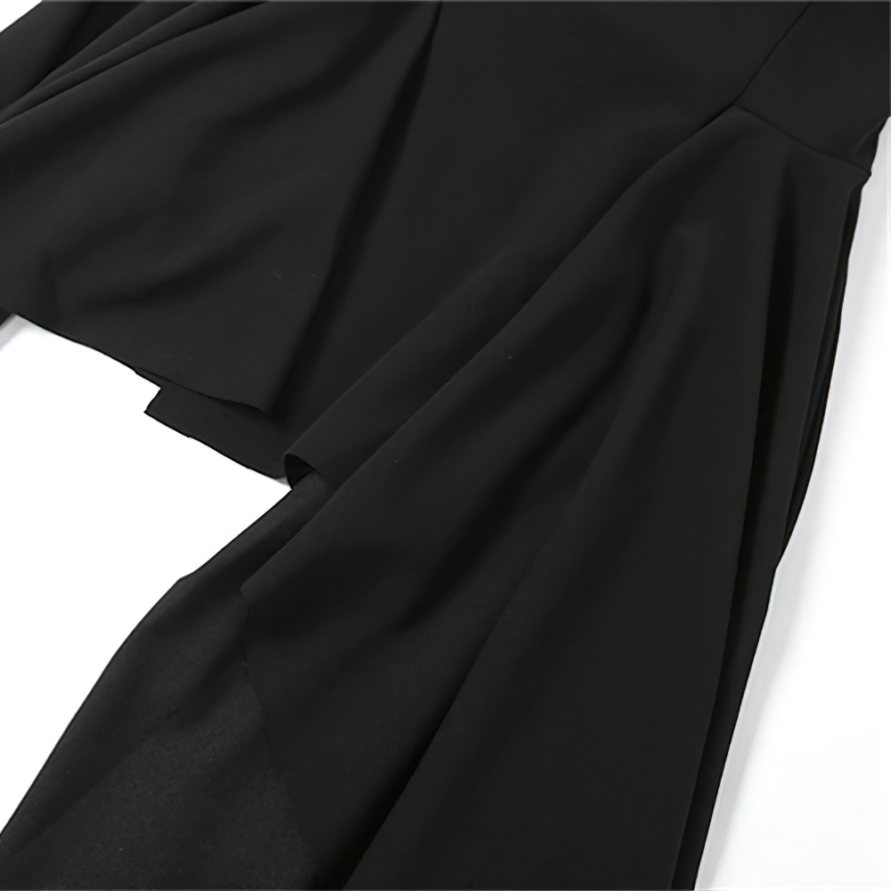 Detail of a black women's asymmetrical dress showcasing elegant fabric and stylish flow, perfect for casual or party wear.