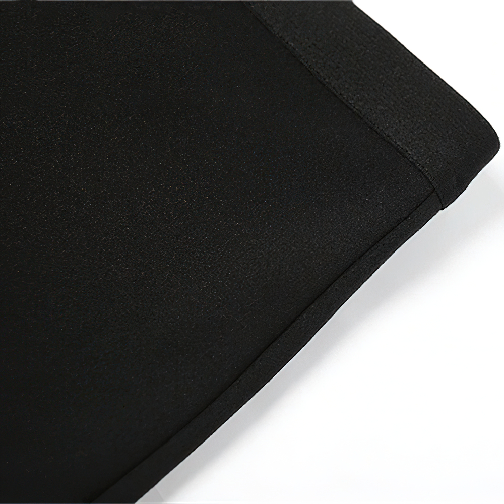 Close-up of the fabric texture of a sexy black women's asymmetrical strapless mini dress.