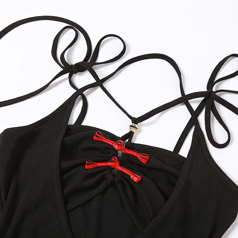 Close-up of the sexy black bodycon dress with decorative red fasteners and stylish straps.