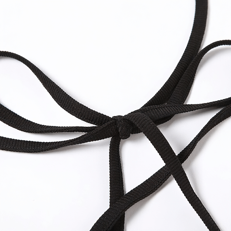 Close-up of black garter straps showcasing a stylish knot detail for a sexy bodycon dress.