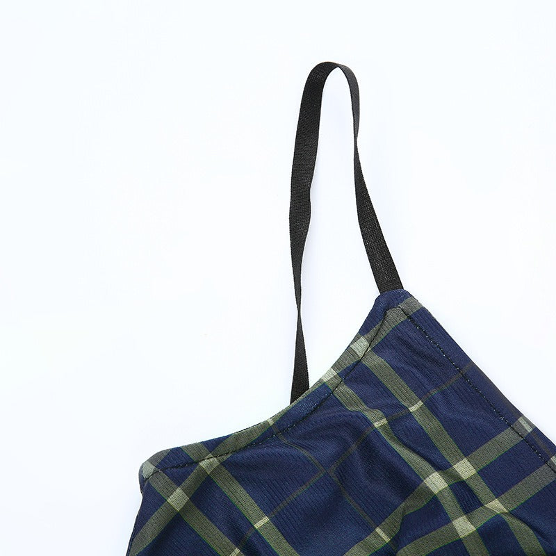 Close-up of the adjustable strap on a women's plaid mini dress in grunge style, showcasing its trendy design.
