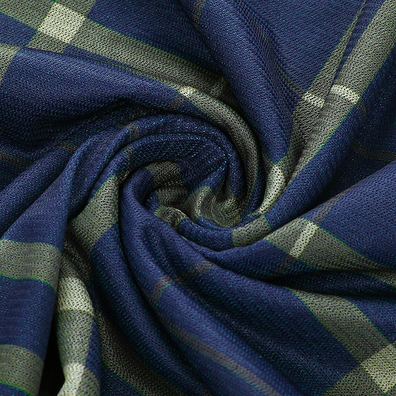 Close-up of plaid fabric in navy and green, perfect for a trendy grunge style mini dress.