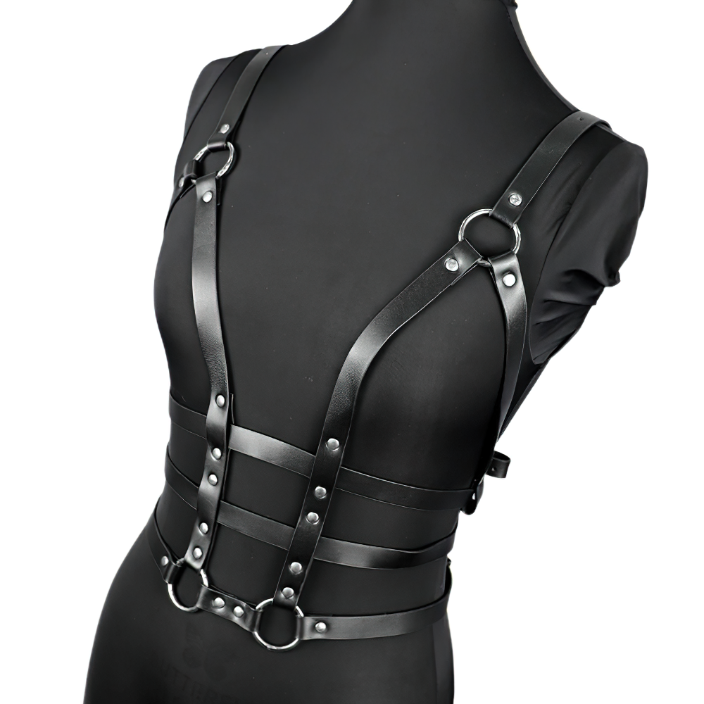 Black leather women's harness with adjustable straps and silver fittings in gothic style.