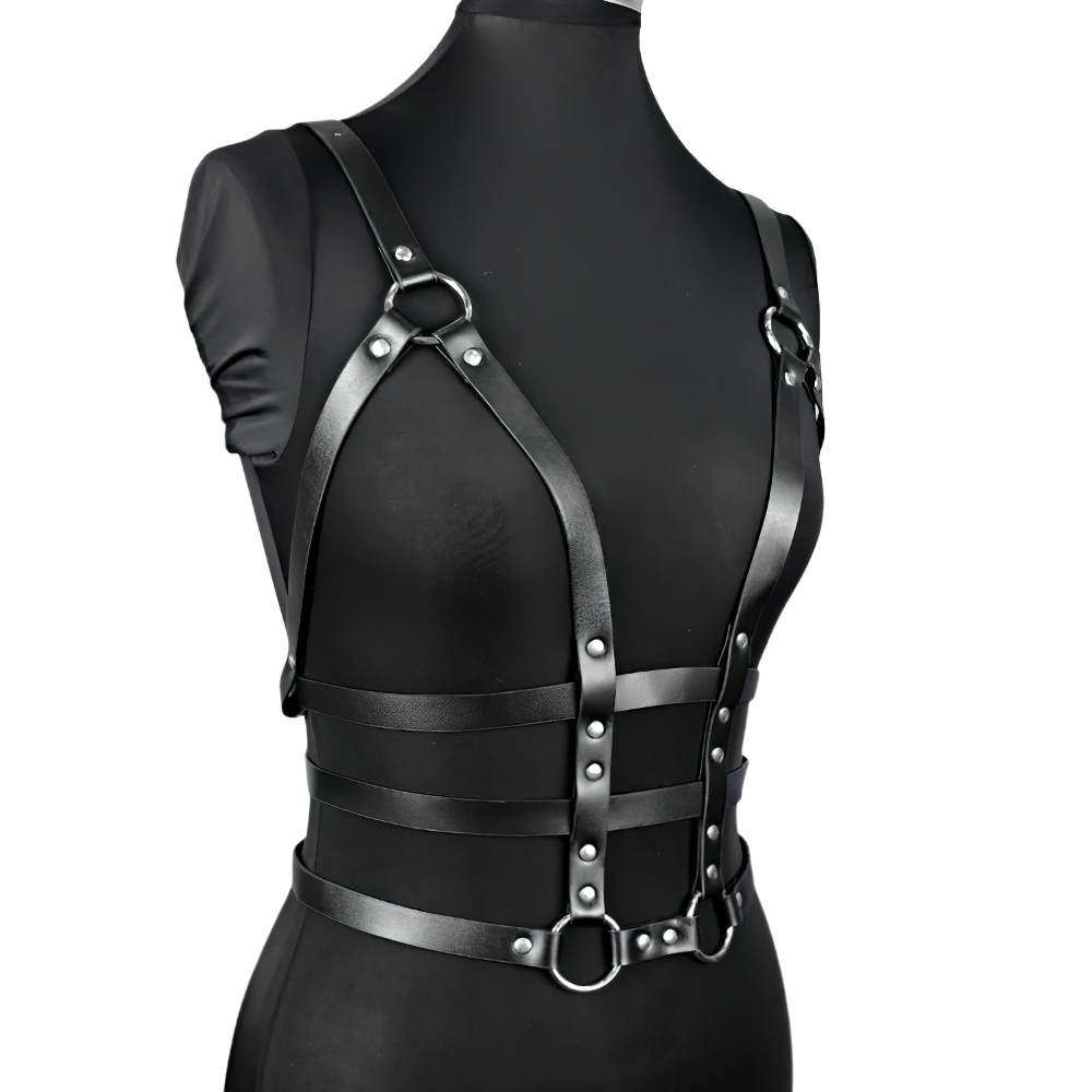 Black leather harness on mannequin, featuring gothic design and adjustable straps for a sexy bondage look.