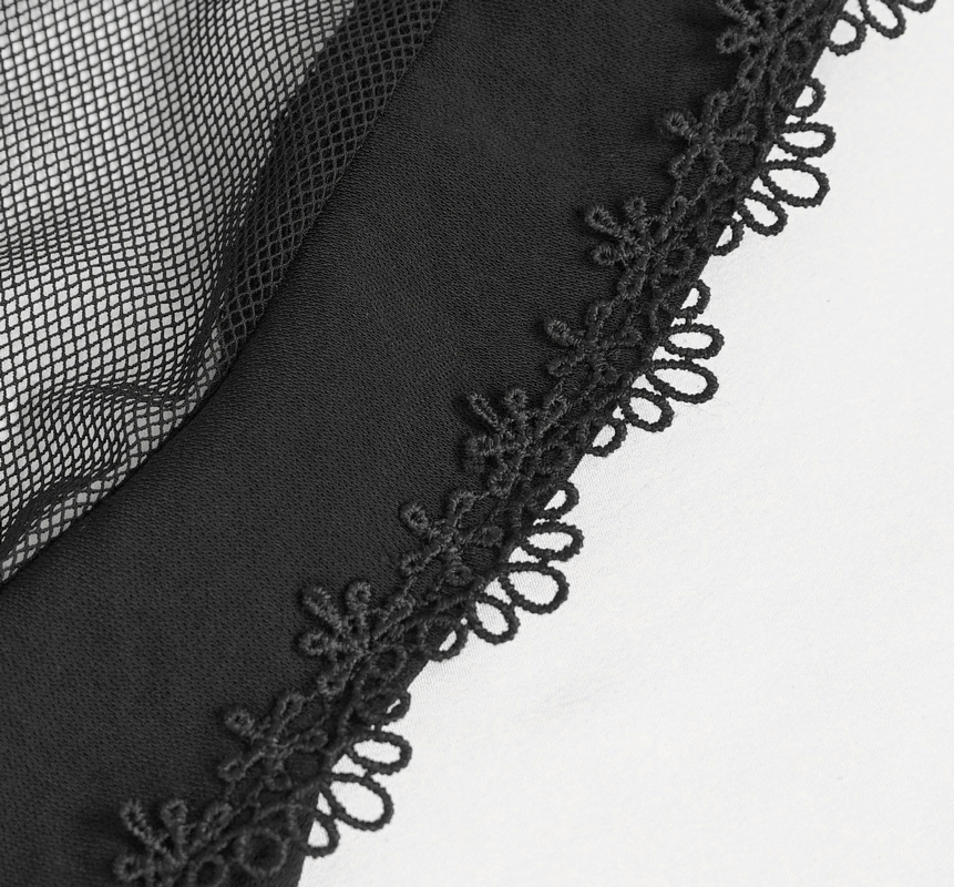 Close-up of gothic blouse fabric featuring black lace trim and mesh detailing on a soft background.
