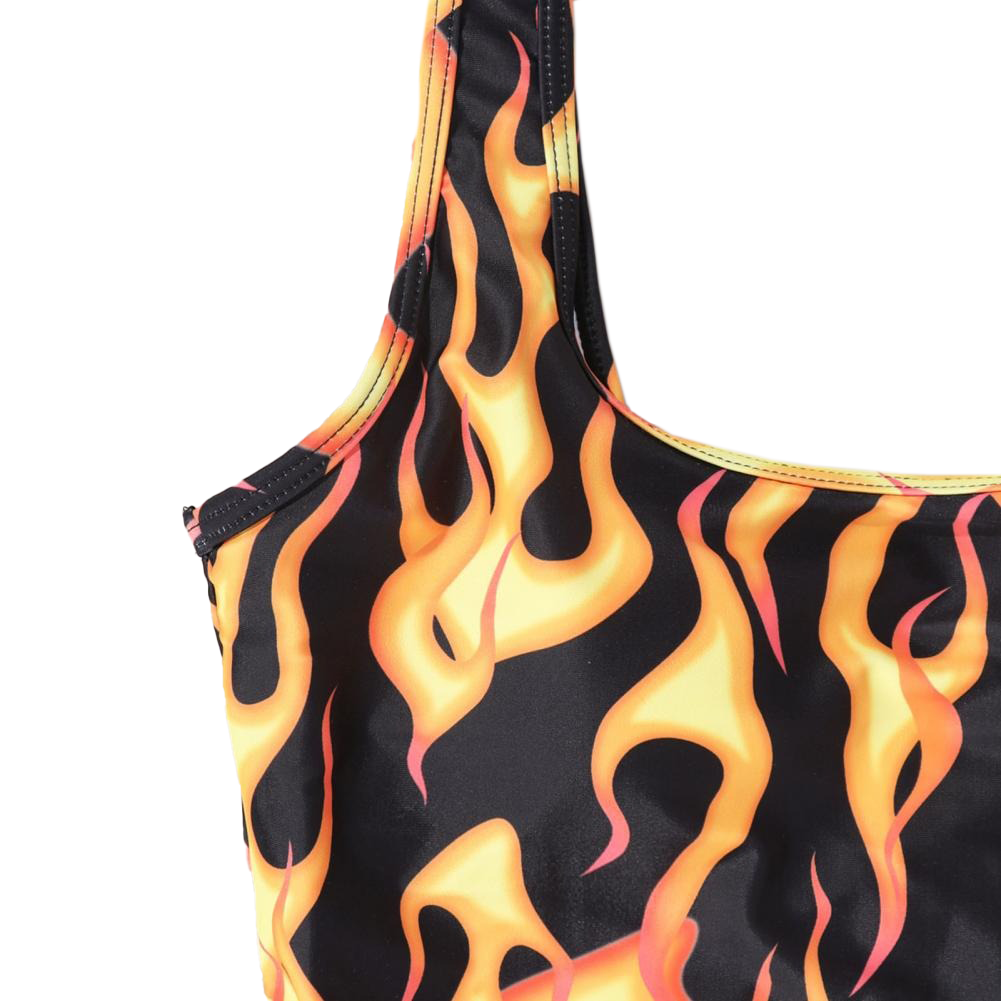 Close-up of vibrant fire print on women's sexy one-piece swimsuit, showcasing bold flames and stylish design.