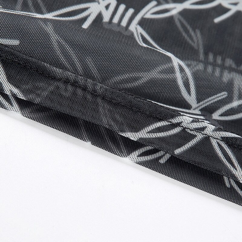 Close-up of stylish black mesh fabric with chain print, perfect for women’s long sleeve crop tops.