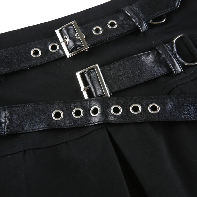 Close-up of black pleated mini skirt showcasing stylish rivet and buckle details for a gothic look.