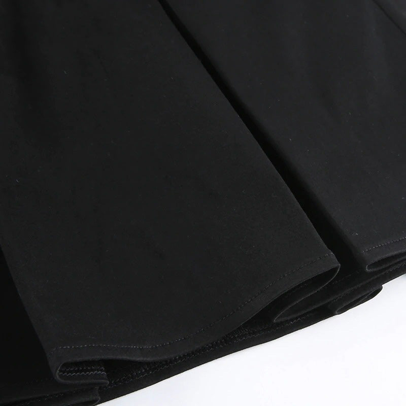 Close-up of a pleated black mini skirt showcasing smooth fabric and stylish hemlines, perfect for gothic-inspired outfits.